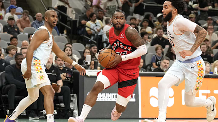 Apr 13, 2025; San Antonio, Texas, USA; Toronto Raptors guard Jamal Shead (23) drives to the basket between San Antonio Spurs forward Julian Champagnie (30) and guard Chris Paul (3) during the first half at Frost Bank Center. Mandatory Credit: Scott Wachter-Imagn Images Apr 13, 2025; San Antonio, Texas, USA; Toronto Raptors guard Jamal Shead (23) drives to the basket between San Antonio Spurs forward Julian Champagnie (30) and guard Chris Paul (3) during the first half at Frost Bank Center. Mandatory Credit: Scott Wachter-Imagn Images