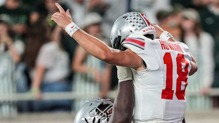 Ohio State Buckeyes quarterback Will Howard (18) is lifted in the air by a teammate after scoring a rushing touchdown duringin the second half of the NCAA football game against Ohio State University at Spartan Stadium in East Lansing, Saturday, Sept. 28, 2024.