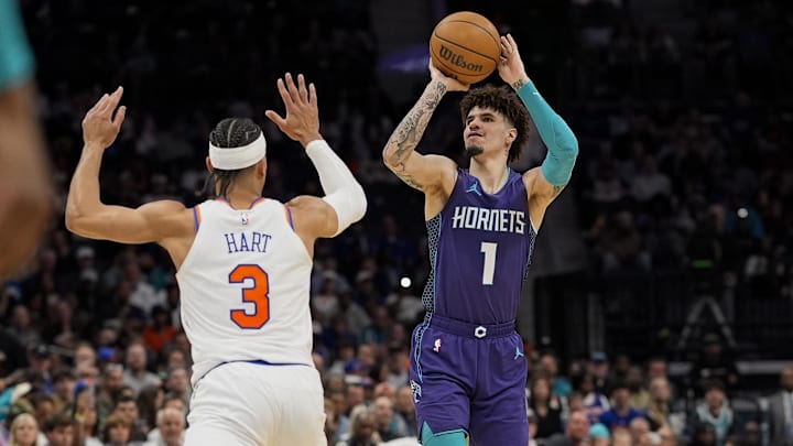 Mar 20, 2025; Charlotte, North Carolina, USA;Charlotte Hornets guard LaMelo Ball (1) shoots a three over New York Knicks guard Josh Hart (3) during the second half at Spectrum Center. Mandatory Credit: Jim Dedmon-Imagn Images