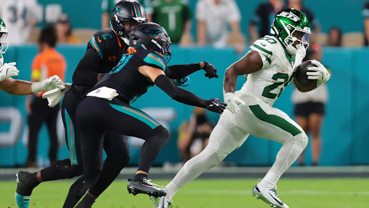 Sep 29, 2025; Miami Gardens, Florida, USA; New York Jets running back Breece Hall (20) rushes the ball against the Miami Dolphins during the first half at Hard Rock Stadium. Mandatory Credit: Sam Navarro-Imagn Images