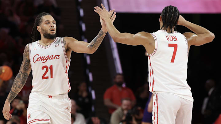 Feb 14, 2026; Houston, Texas, USA; Houston Cougars guard Emanuel Sharp (21) celebrates guard Milos Uzan (7) three point basket against the Kansas State Wildcats in the first half at Fertitta Center.