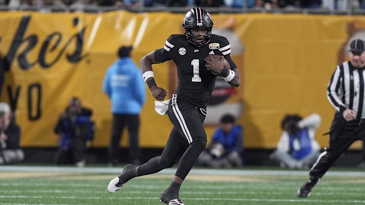 Jan 2, 2026; Charlotte, NC, USA; Mississippi State Bulldogs quarterback Kamario Taylor (1) runs for yardage against the Wake Forest Demon Deacons during the first quarter at Bank of America Stadium. Mandatory Credit: Jim Dedmon-Imagn Images Jan 2, 2026; Charlotte, NC, USA; Mississippi State Bulldogs quarterback Kamario Taylor (1) runs for yardage against the Wake Forest Demon Deacons during the first quarter at Bank of America Stadium. Mandatory Credit: Jim Dedmon-Imagn Images