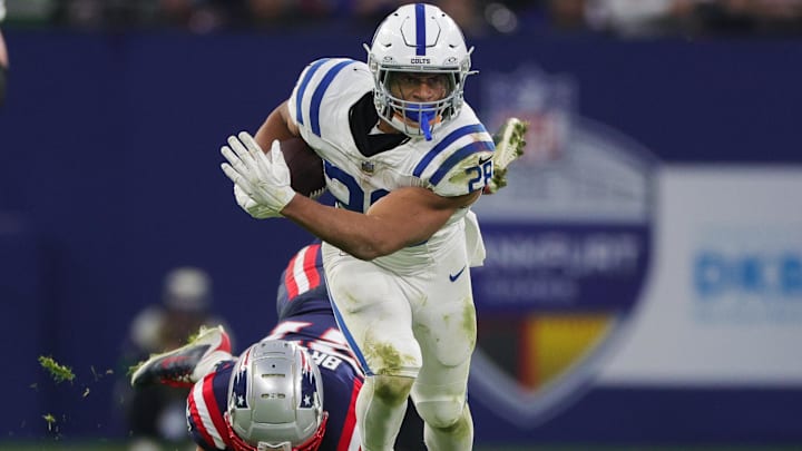 Nov 12, 2023; Frankfurt, Germany; Indianapolis Colts running back Jonathan Taylor (28) breaks a tackle from New England Patriots cornerback Myles Bryant (27) in the second quarter during an International Series game at Deutsche Bank Park. Mandatory Credit: Nathan Ray Seebeck-Imagn Images Nov 12, 2023; Frankfurt, Germany; Indianapolis Colts running back Jonathan Taylor (28) breaks a tackle from New England Patriots cornerback Myles Bryant (27) in the second quarter during an International Series game at Deutsche Bank Park. Mandatory Credit: Nathan Ray Seebeck-Imagn Images