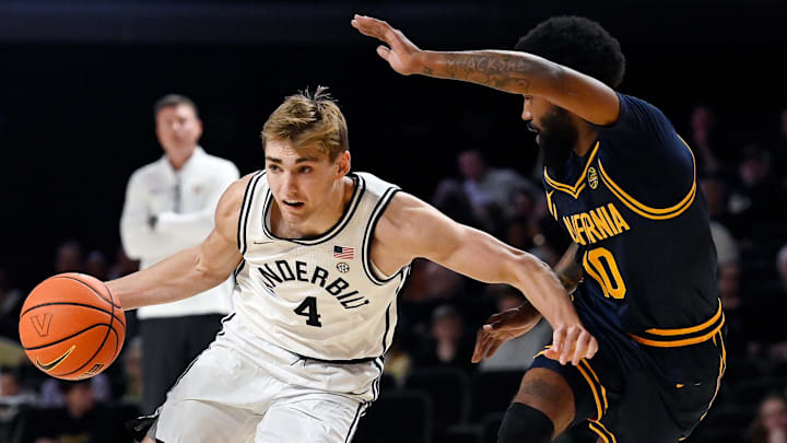 Vanderbilt's Grant Huffman drives by Cal's Jovan Blacksher Jr. Vanderbilt's Grant Huffman drives by Cal's Jovan Blacksher Jr.