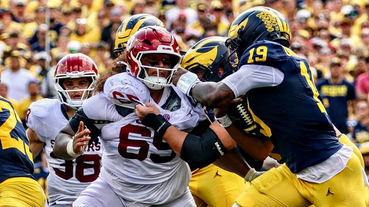 Oklahoma defensive tackle Jayden Jackson pursues Michigan quarterback Bryce Underwood. Oklahoma defensive tackle Jayden Jackson pursues Michigan quarterback Bryce Underwood.