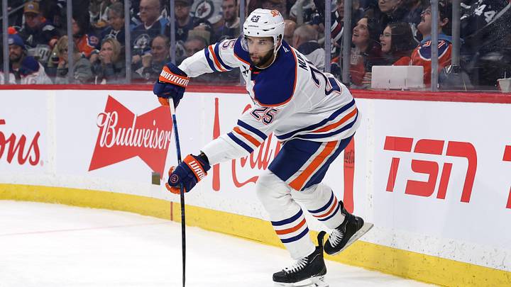 Jan 8, 2026; Winnipeg, Manitoba, CAN; Edmonton Oilers defenseman Darnell Nurse (25) shoots the puck up the ice during a game against the Winnipeg Jets in the second period at Canada Life Centre. Mandatory Credit: James Carey Lauder-Imagn Images