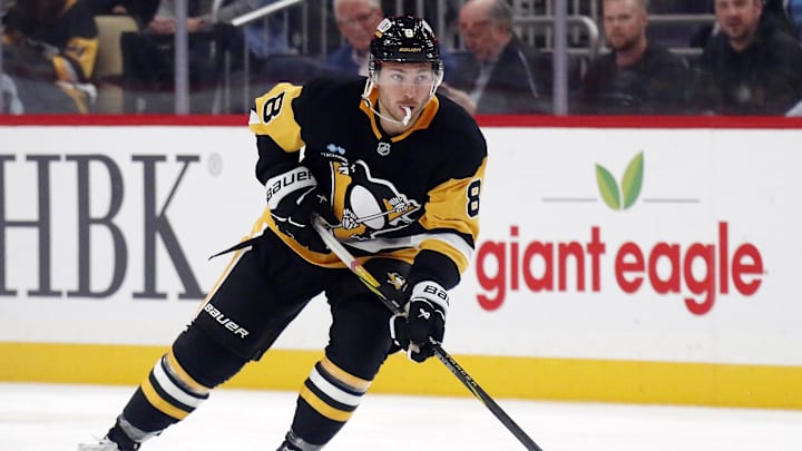 Oct 16, 2024; Pittsburgh, Pennsylvania, USA; Pittsburgh Penguins left wing Michael Bunting (8) skates with the puck against the Buffalo Sabres during the third period at PPG Paints Arena. The Pens won 6-5 in overtime. Mandatory Credit: Charles LeClaire-Imagn Images