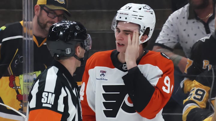 Apr 18, 2026; Pittsburgh, Pennsylvania, USA; Referee Chris Rooney (5) checks Philadelphia Flyers right wing Porter Martone (94) after Martone was high-sticked by the Pittsburgh Penguins during the third period against in game one of the first round of the 2026 Stanley Cup Playoffs at PPG Paints Arena. Mandatory Credit: Charles LeClaire-Imagn Images