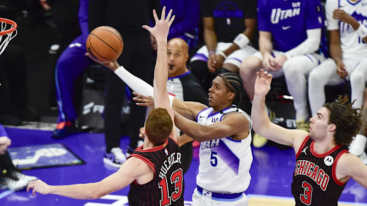 Nov 16, 2025; Salt Lake City, Utah, USA; Utah Jazz forward Cody Williams (5) makes a layup around Chicago Bulls guard/forward Kevin Huerter (13) and Chicago Bulls guard Josh Giddey (3) during the second half at Delta Center. Mandatory Credit: Peter Creveling-Imagn Images