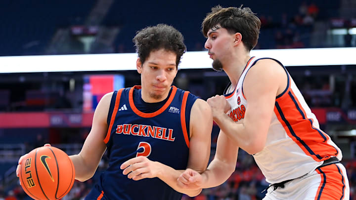 Dec 28, 2024; Syracuse, New York, USA; Bucknell Bison center Noah Williamson (3) drives against Syracuse Orange forward Petar Majstorovic (right) during the second half at the JMA Wireless Dome. Mandatory Credit: Rich Barnes-Imagn Images