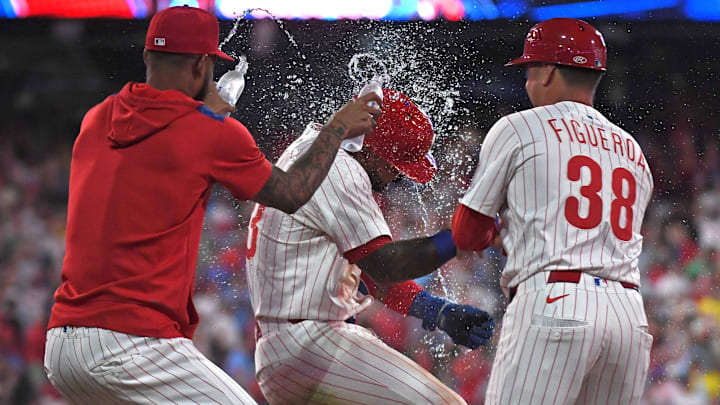 Jul 21, 2025; Philadelphia, Pennsylvania, USA; Philadelphia Phillies second base Edmundo Sosa (33) celebrates a walk-off win on catcher's interference with teammates during the tenth inning against the Boston Red Sox at Citizens Bank Park