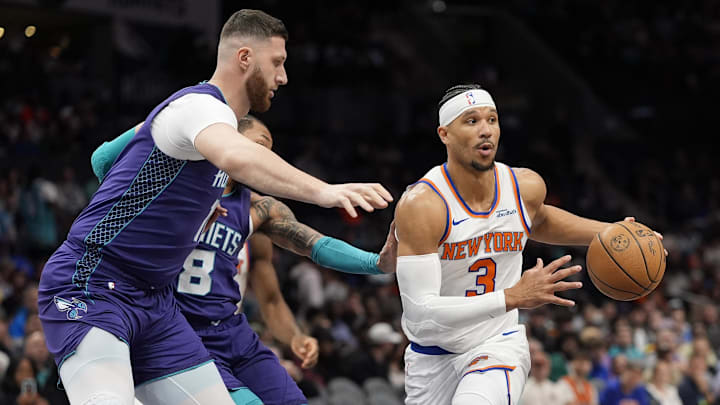 Mar 20, 2025; Charlotte, North Carolina, USA; New York Knicks guard Josh Hart (3) passes off under pressure from Charlotte Hornets center Jusuf Nurkic (11) during the first quarter at Spectrum Center. Mandatory Credit: Jim Dedmon-Imagn Images
