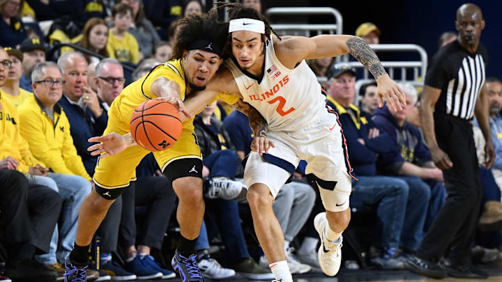 Mar 2, 2025; Ann Arbor, Michigan, USA; Michigan Wolverines guard Tre Donaldson (3) battles Illinois Fighting Illini guard Dra Gibbs-Lawhorn (2) for a loose ball in the first half at Crisler Center. Mandatory Credit: Lon Horwedel-Imagn Images