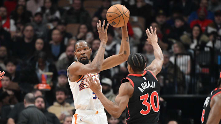 Feb 23, 2025; Toronto, Ontario, CAN;  Phoenix Suns forward Kevin Durant (35) takes in a pass over Toronto Raptors guard Ochai Agbaji (30) in the first half at Scotiabank Arena. Mandatory Credit: Dan Hamilton-Imagn Images