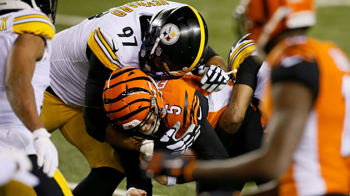 Cincinnati Bengals quarterback Ryan Finley (5) is tackled by Pittsburgh Steelers defensive end Cameron Heyward (97) as he runs a QB keeper in the second quarter of the NFL 15 game between the Cincinnati Bengals and the Pittsburgh Steelers at Paul Brown Stadium in downtown Cincinnati on Monday, Dec. 21, 2020. The Bengals led 17-0 at halftime.
Pittsburgh Steelers At Cincinnati Bengals Cincinnati Bengals quarterback Ryan Finley (5) is tackled by Pittsburgh Steelers defensive end Cameron Heyward (97) as he runs a QB keeper in the second quarter of the NFL 15 game between the Cincinnati Bengals and the Pittsburgh Steelers at Paul Brown Stadium in downtown Cincinnati on Monday, Dec. 21, 2020. The Bengals led 17-0 at halftime.
Pittsburgh Steelers At Cincinnati Bengals