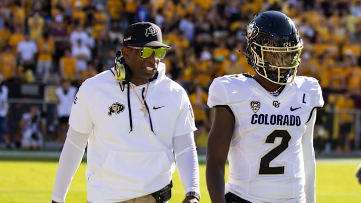 Oct 7, 2023; Tempe, Arizona, USA; Colorado Buffaloes head coach Deion Sanders with son and quarterback Shedeur Sanders (2) against the Arizona State Sun Devils at Mountain America Stadium. Mandatory Credit: Mark J. Rebilas-Imagn Images