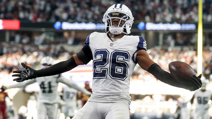 Dallas Cowboys cornerback Daron Bland (26) carries the ball after an interception for a touchdown against the Washington Commanders during the third quarter of the game at AT&T Stadium. Mandatory Credit: Kevin Jairaj-Imagn Images