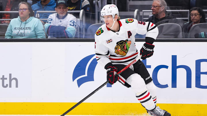 Nov 3, 2025; Seattle, Washington, USA; Chicago Blackhawks defenseman Connor Murphy (5) controls the puck in the second period against the Seattle Kraken at Climate Pledge Arena. Mandatory Credit: Kevin Ng-Imagn Images