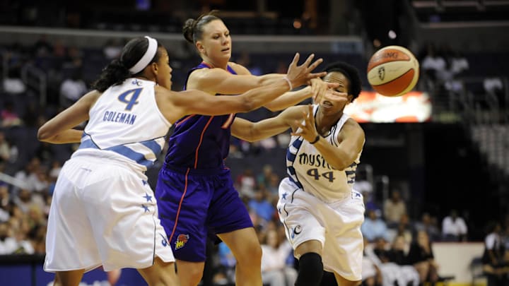 June 27, 2010; Washington, DC, USA; Phoenix Mercury forward Penny Taylor (center) gets a pass off in between Washington Mystics players Chasity Melvin (44) and Marissa Coleman (4) during the first half at the Verizon Center.  Mandatory Credit: Rafael Suanes-Imagn Images