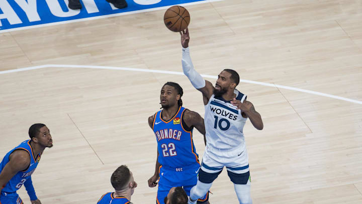 May 22, 2025; Oklahoma City, Oklahoma, USA; Minnesota Timberwolves guard Mike Conley (10) shoots against Oklahoma City Thunder guard Cason Wallace (22) in the fourth quarter during game two of the western conference finals for the 2025 NBA Playoffs at Paycom Center. Mandatory Credit: Brett Rojo-Imagn Images