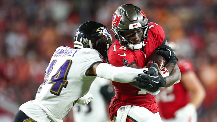 Oct 21, 2024; Tampa, Florida, USA; Tampa Bay Buccaneers wide receiver Chris Godwin (14) is pressured by Baltimore Ravens cornerback Marlon Humphrey (44) in the second quarter at Raymond James Stadium. Mandatory Credit: Nathan Ray Seebeck-Imagn Images