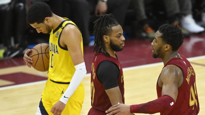 Apr 12, 2024; Cleveland, Ohio, USA; Indiana Pacers guard Tyrese Haliburton (0) and Cleveland Cavaliers guard Donovan Mitchell (45) react after a three-point basket by guard Darius Garland (10) in the fourth quarter at Rocket Mortgage FieldHouse. Mandatory Credit: David Richard-USA TODAY Sports