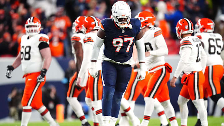 Dec 2, 2024; Denver, Colorado, USA; Denver Broncos defensive tackle Malcolm Roach (97) celebrates a missed field goal by the Cleveland Browns in the first quarter at Empower Field at Mile High. Mandatory Credit: Ron Chenoy-Imagn Images