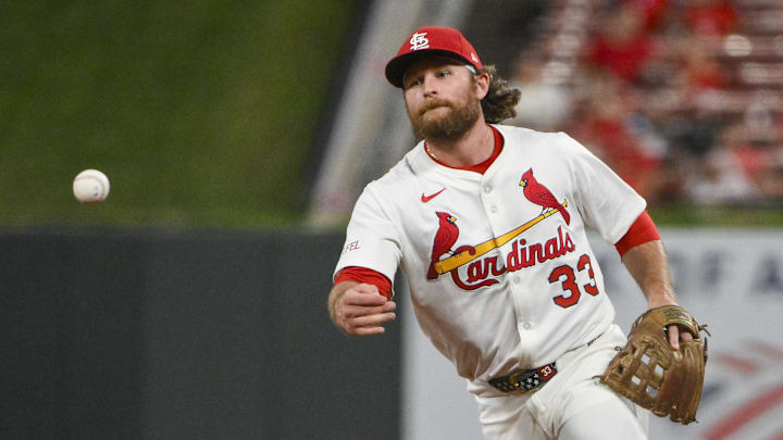 Aug 11, 2025; St. Louis, Missouri, USA;  St. Louis Cardinals second baseman Brendan Donovan (33) flips the ball to first base during the ninth inning against the Colorado Rockies at Busch Stadium. Mandatory Credit: Jeff Curry-Imagn Images