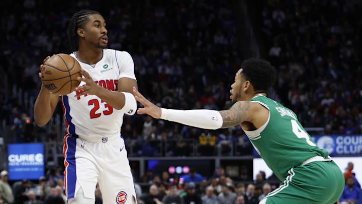 Jan 19, 2026; Detroit, Michigan, USA;  Detroit Pistons guard Jaden Ivey (23) looks to pass the ball against Boston Celtics guard Anfernee Simons (4) in the second half at Little Caesars Arena. Mandatory Credit: Rick Osentoski-Imagn Images