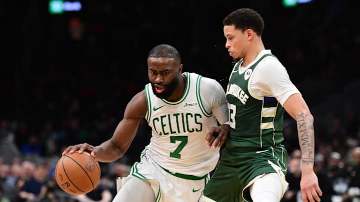 Feb 1, 2026; Boston, Massachusetts, USA; Boston Celtics guard Jaylen Brown (7) controls the ball while Milwaukee Bucks guard Ryan Rollins (13) defends during the second half at TD Garden. Mandatory Credit: Bob DeChiara-Imagn Images