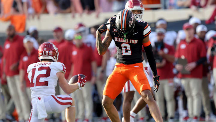 Oklahoma State's Korie Black (2) celebrates a defensive stop next to Oklahoma's Drake Stoops (12) during a Bedlam college football game between the Oklahoma State University Cowboys (OSU) and the University of Oklahoma Sooners (OU) at Boone Pickens Stadium in Stillwater, Okla., Saturday, Nov. 4, 2023.