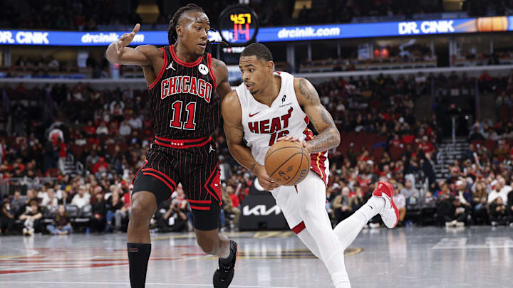 Nov 21, 2025; Chicago, Illinois, USA; Miami Heat forward Keshad Johnson (16) drives to the basket against Chicago Bulls guard Ayo Dosunmu (11) during the second half at United Center. Mandatory Credit: Kamil Krzaczynski-Imagn Images