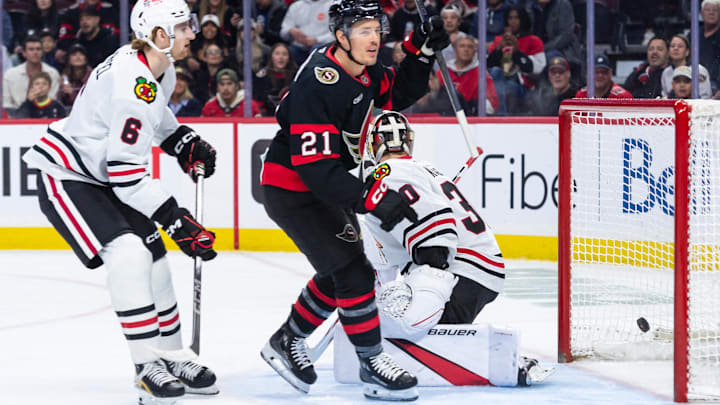 Apr 15, 2025; Ottawa, Ontario, CAN; Ottawa Senators center Nick Cousins (21) scores against Chicago Blackhawks goalie Spencer Knight (30) in the first period at the Canadian Tire Centre. Mandatory Credit: Marc DesRosiers-Imagn Images