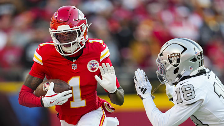 Nov 29, 2024; Kansas City, Missouri, USA; Kansas City Chiefs wide receiver Xavier Worthy (1) runs with the ball against Las Vegas Raiders cornerback Darnay Holmes (30) during the first half at GEHA Field at Arrowhead Stadium. Mandatory Credit: Jay Biggerstaff-Imagn Images