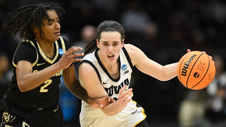 Iowa's Caitlin Clark (22) tries to get to the basket while guarded by Colorado's Tameiya Sadler (2).