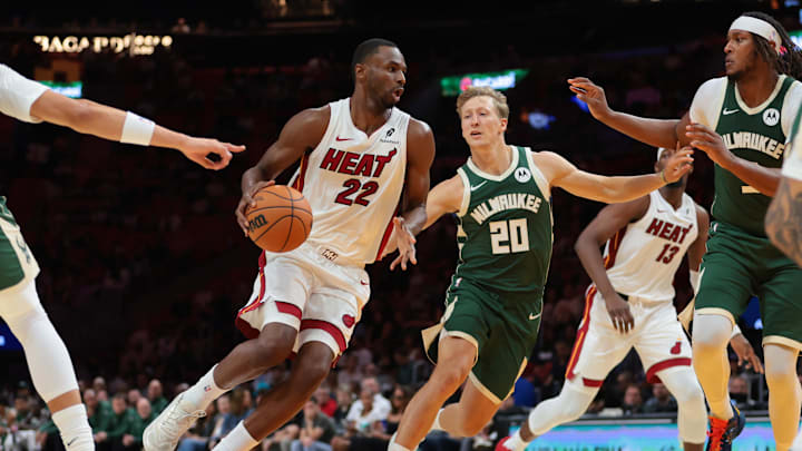 Oct 6, 2025; Miami, Florida, USA; Miami Heat forward Andrew Wiggins (22) drives to the basket against Milwaukee Bucks guard AJ Green (20) during the second quarter at Kaseya Center. Mandatory Credit: Sam Navarro-Imagn Images
