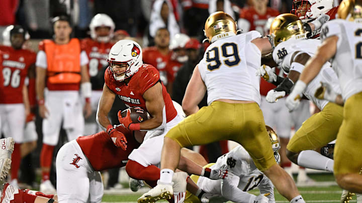 Oct 7, 2023; Louisville, Kentucky, USA; Louisville Cardinals running back Isaac Guerendo (23) runs the ball against Notre Dame Fighting Irish defensive lineman Rylie Mills (99) during the second half at L&N Federal Credit Union Stadium. Louisville defeated Notre Dame 33-20.