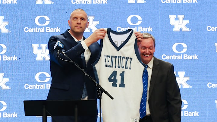 Former Kentucky basketball player and new Kentucky head coach Mark Pope, left, called athletic director Mitch Barnhart back to the stage so he could have a portrait with his actual game jersey as opposed to the random jersey Barnhart chose during his announcement at Rupp Arena in Lexington Ky. on April 14, 2024.