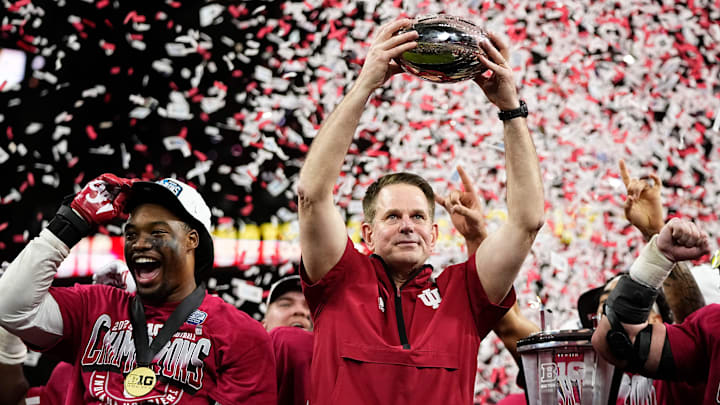 Indiana Hoosiers head coach Curt Cignetti hoists the trophy following their win over the Ohio State Buckeyes following the Big Ten Conference championship game at Lucas Oil Stadium in Indianapolis on Dec. 6, 2025. Ohio State lost 13-10. Indiana Hoosiers head coach Curt Cignetti hoists the trophy following their win over the Ohio State Buckeyes following the Big Ten Conference championship game at Lucas Oil Stadium in Indianapolis on Dec. 6, 2025. Ohio State lost 13-10.