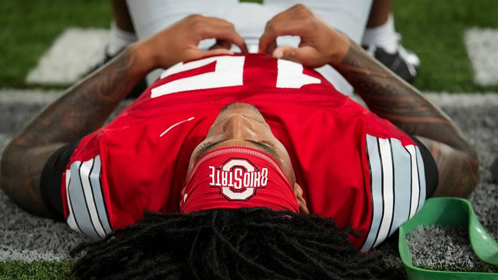 Ohio State Buckeyes wide receiver Chris Henry Jr. (15) stretches during football training camp inside the Woody Hayes Athletic Center in Columbus on Aug. 7, 2026.