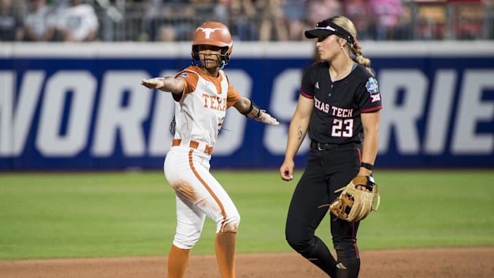 Jun 4, 2025; Oklahoma City, OK, USA; Texas Longhorns outfielder Kayden Henry (21) signals herself safe after stealing second as Texas Tech Red Raiders infielder Alexa Langeliers (23) looks on in the sixth inning during game one of the NCAA Softball Women's College World Series finals at Devon Park. Mandatory Credit: Brett Rojo-Imagn Images Jun 4, 2025; Oklahoma City, OK, USA; Texas Longhorns outfielder Kayden Henry (21) signals herself safe after stealing second as Texas Tech Red Raiders infielder Alexa Langeliers (23) looks on in the sixth inning during game one of the NCAA Softball Women's College World Series finals at Devon Park. Mandatory Credit: Brett Rojo-Imagn Images