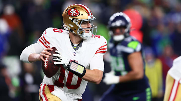 Jan 17, 2026; Seattle, WA, USA; San Francisco 49ers quarterback Mac Jones (10) rolls out against the Seattle Seahawks during the second half in an NFC Divisional Round game at Lumen Field. Mandatory Credit: Kevin Ng-Imagn Images