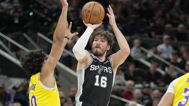Dec 13, 2023; San Antonio, Texas, USA; San Antonio Spurs forward Cedi Osman (16) shoots over Los Angeles Lakers guard Max Christie (10) in the first half at Frost Bank Center. 
