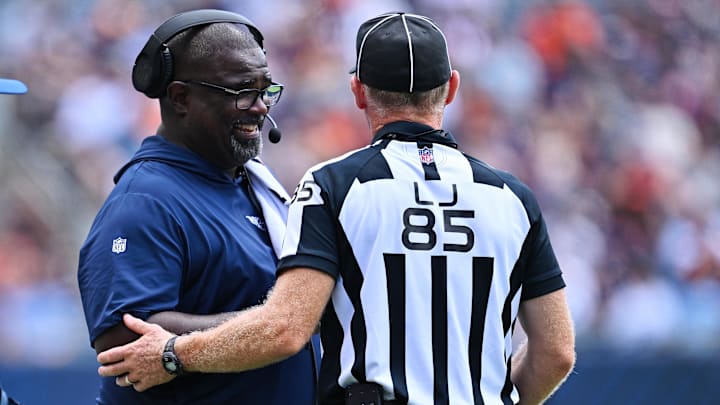 Aug 12, 2023; Chicago, Illinois, USA;  Tennessee Titans Assistant Head Coach Terrell Williams talks with Line Judge Daniel Gallagher (85) in the second half against the Chicago Bears at Soldier Field. Mandatory Credit: Jamie Sabau-Imagn Images