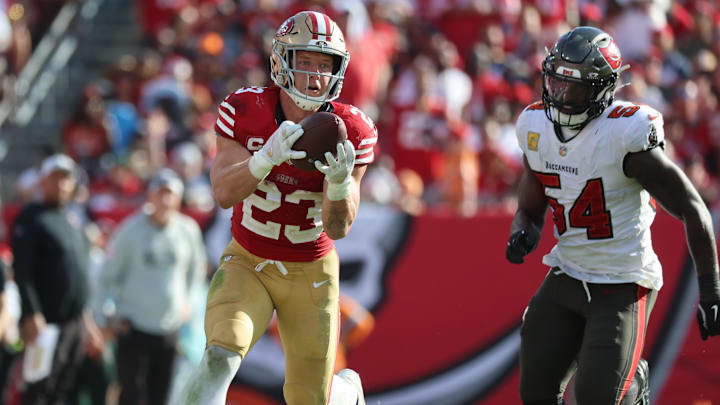 Nov 10, 2024; Tampa, Florida, USA; San Francisco 49ers running back Christian McCaffrey (23) catches the ball over Tampa Bay Buccaneers linebacker Lavonte David (54) during the second half at Raymond James Stadium. Mandatory Credit: Kim Klement Neitzel-Imagn Images