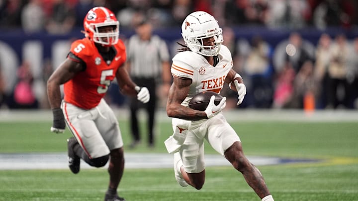 Dec 7, 2024; Atlanta, GA, USA; Texas Longhorns wide receiver Isaiah Bond (7) makes a catch past Georgia Bulldogs linebacker Raylen Wilson (5) during the first half in the 2024 SEC Championship game at Mercedes-Benz Stadium