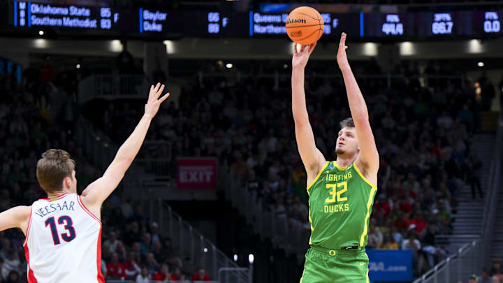 Mar 23, 2025; Seattle, WA, USA;  Oregon Ducks center Nate Bittle (32) attempts a 3-point shot against Arizona Wildcats forward Henri Veesaar (13) in the first half at Climate Pledge Arena. Mandatory Credit: Steven Bisig-Imagn Images