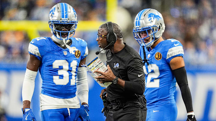 Detroit Lions defensive coordinator Aaron Glenn talks to safety Kerby Joseph (31), left, and safety Brian Branch (32) during the first half against Chicago Bears at Ford Field in Detroit on Thursday, Nov. 28, 2024.