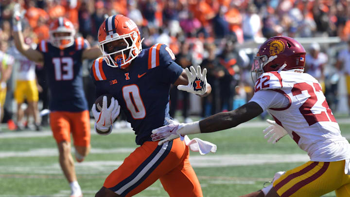 Sep 27, 2025; Champaign, Illinois, USA; Illinois Fighting Illini wide receiver Justin Bowick (0) runs past Southern California Trojans cornerback Braylon Conley (22) and scores on a 25 yard reception for a touchdown during the second half at Memorial Stadium. Mandatory Credit: Ron Johnson-Imagn Images