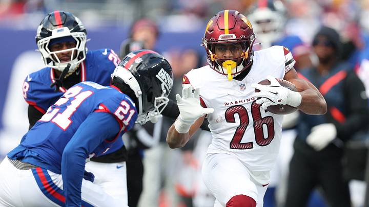 Dec 14, 2025; East Rutherford, New Jersey, USA; Washington Commanders running back Jeremy McNichols (26) runs with the ball against New York Giants cornerback Paulson Adebo (21) during the second quarter at MetLife Stadium. Mandatory Credit: Vincent Carchietta-Imagn Images Dec 14, 2025; East Rutherford, New Jersey, USA; Washington Commanders running back Jeremy McNichols (26) runs with the ball against New York Giants cornerback Paulson Adebo (21) during the second quarter at MetLife Stadium. Mandatory Credit: Vincent Carchietta-Imagn Images